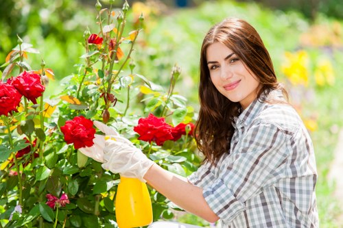 Gardeners transferring sorted green waste at local facility