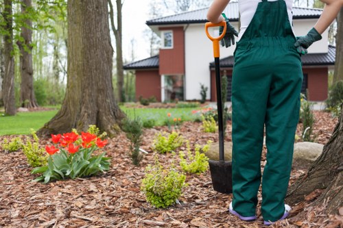 Happy homeowners with their Gardeners Pinner-enhanced garden
